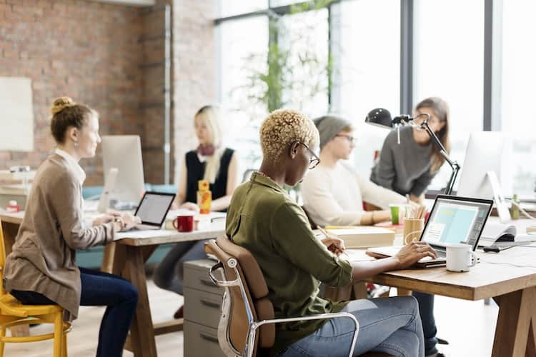 Coworkers sitting around on laptops