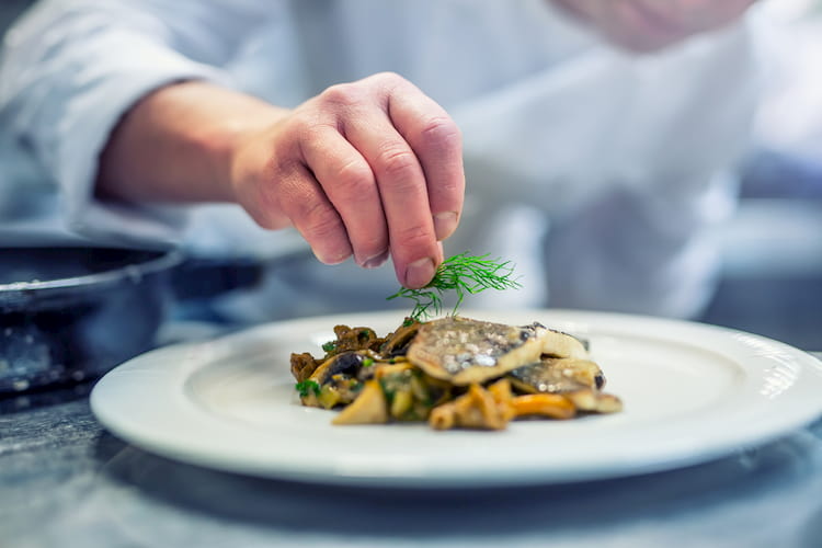 a chef prepares a fine seafood dish