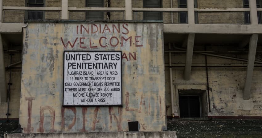 The sign at the entrance of the federal prison on Alcatraz Island, graffiti from the Indians of All Tribes occupation visible on the walls