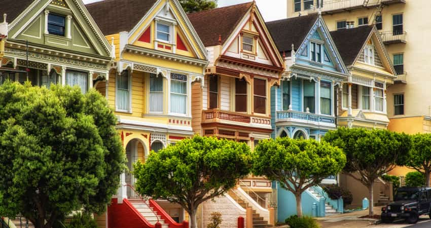 Brightly painted Victorian houses line a street in San Francisco