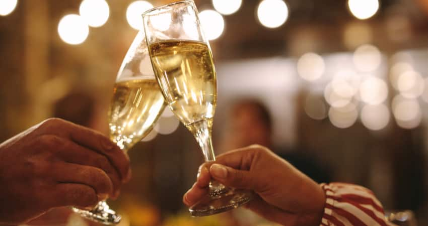 People toasting champagne at an upscale restaurant during evening dinner