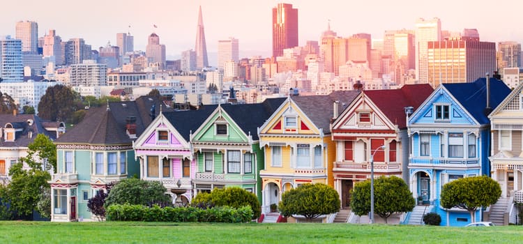 san francisco's "painted ladies" houses in pink, green, yellow, red, and blue, all in a row