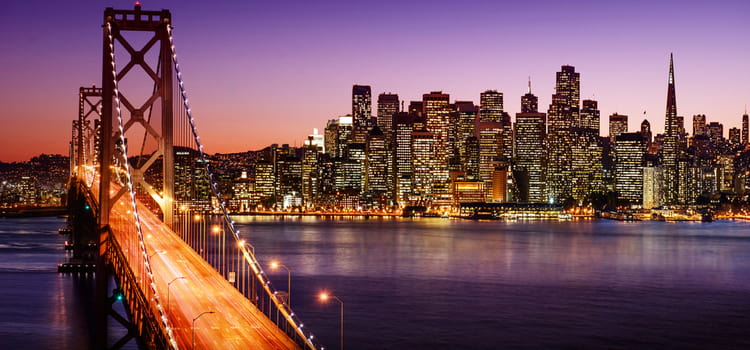 a view of the golden gate bridge and san francisco across the bay right after sunset